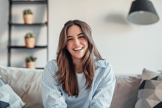 Happy cheerful student talking to the camera, connecting in conference video call with coworkers or friends. Having fun telling distance family her new experiences