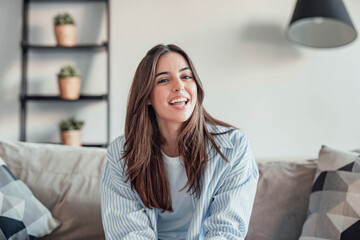 Happy cheerful student talking to the camera, connecting in conference video call with coworkers or friends. Having fun telling distance family her new experiences