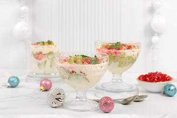 Kiwi and pomegranate parfait on a bright festive table, an idea for decorating food and decorating New Year's dishes. Banner for the screen , template for creativity. Christmas and New Year's dishes.