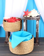 Woven baskets and seashells on rustic stands