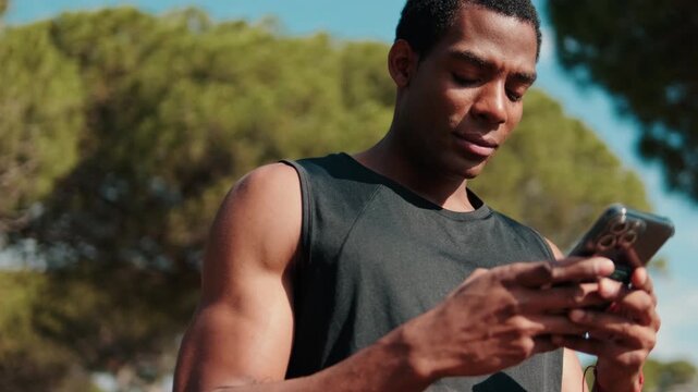 Athlete Checks Fitness App on Phone After Workout