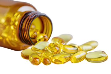 Amber glass bottle spilling golden capsules