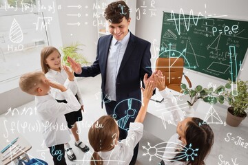 Male teacher giving high-fives to little pupils in classroom