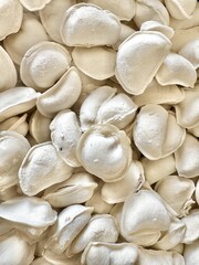 Close up of homemade dumplings with flour on surface ready for boiling