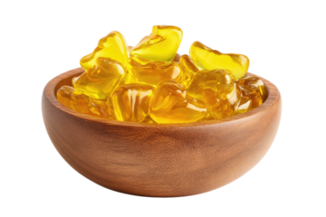 Golden, translucent, heart-shaped candies in a wooden bowl