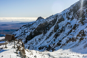 Snow-covered cliffs and rugged volcanic terrain at Whakapapa Ski Field in New Zealand