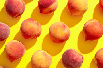Sweet ripe peaches on yellow background
