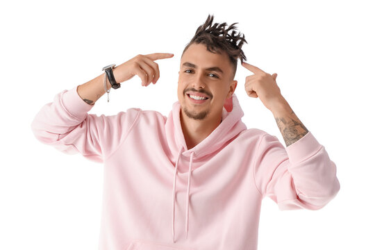 Young man in hoodie pointing at his dreadlocks on white background