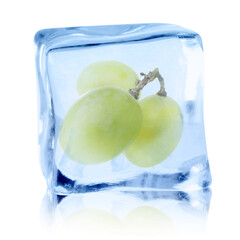 Fresh grapes inside ice cube on white background