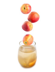 Compot ingredients. Fresh apples falling into glass of drink against white background