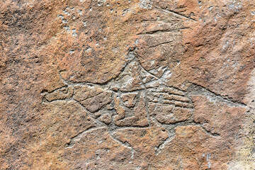 Obraz premium Ancient Rock Art Depicting a Human Figure with Elaborate Headwear