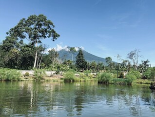 View of Mount Dempo in Pagaralam, South Sumatra, on a lake with bungalows facing the mountain as clear sky
