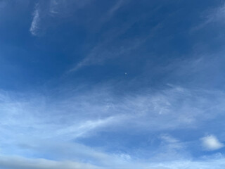Blue sky with scattered white clouds in natural daylight