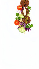 Vertical Composition of Falafel, Vegetables, and Parsley on a Clean White Surface