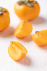 Sliced fresh ripe persimmon on white background, Autumn sweet fruit