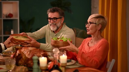 Senior couple enjoying thanksgiving dinner with family