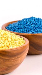 Wooden bowls filled with small, colorful pellets