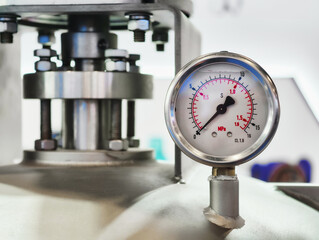 Pressurized gauge measures fluid dynamics in a modern industrial environment with precision and clarity during a bustling workday