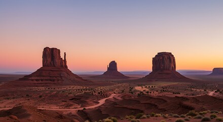 Monument Valley sandstone buttes at sunset with winding dirt road arizona utah