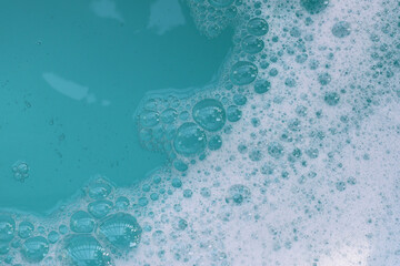 Foamy blue water surface with bubbles.