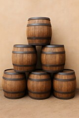 Fototapeta premium An eye-level shot of a pyramid of six rustic wooden barrels with metal bands, stacked against a tan wall on a dirt ground.