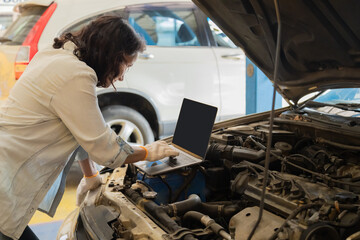 Small business, garage, mechanic, woman, Female owner manages auto maintenance shop using technology to inspect vehicle repair, balancing work with technology, professional car service, customer care