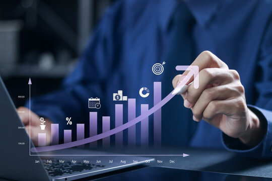 Investing for financial growth concept. Increase in income and wages, financial growth, improvement of economy, profitability of investment portfolio. Businessman use laptop with virtual chart.