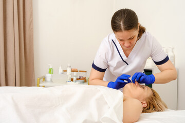Massage therapist gives woman oil massage. 