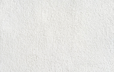Close-up texture of white soft terry cloth fabric for background or design inspiration.