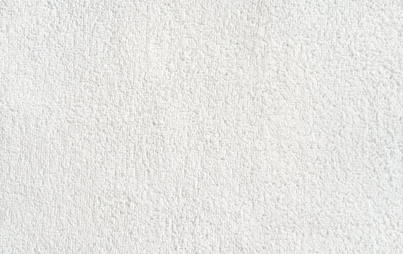 Close-up texture of white soft terry cloth fabric for background or design inspiration.