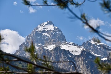 there is a large mountain with a snow covered peak in the background