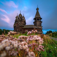 Wooden church at dawn, wildflowers foreground