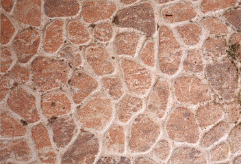 The stone floor is decorated with a variety of geometric mosaic tiles, yellow, brown, white. Abstract chaotic geometric patterns.