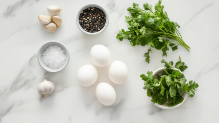 Fresh green herbs, eggs, and spices on a marble countertop.