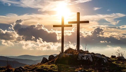 Two wooden crosses silhouetted against a dramatic sunset sky atop a rocky hill. The sun's rays shine brightly