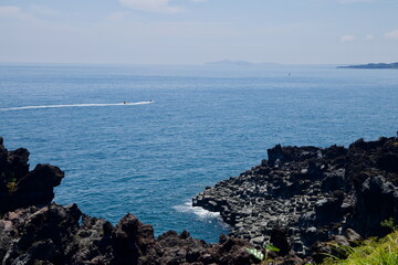Boat Beyond Basalt Cliffs