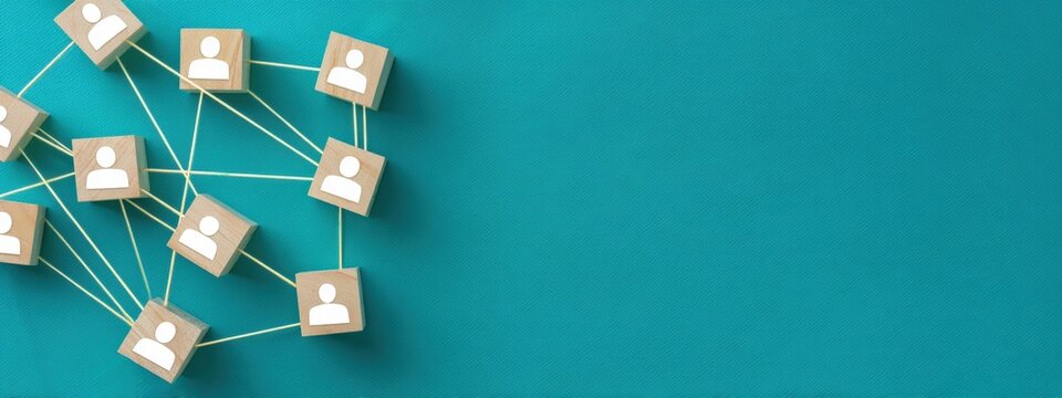 Interconnected wooden cubes with person icons symbolize networking, teamwork, and social connections on a vibrant teal background