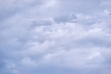 Overcast sky with thick gray clouds covering the entire view in a calm and quiet atmosphere.