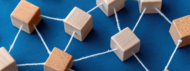 Interconnected wooden blocks symbolize teamwork, network, and cooperation, representing a strong and unified structure