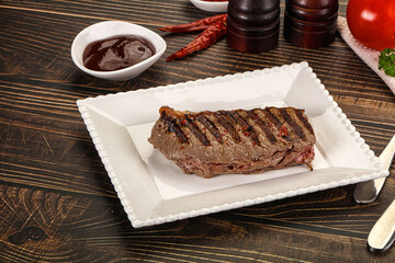 Grilled beef striploin steak with sauce