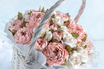 Beautiful arrangement of pink and white marshmallow flowers in a woven basket, showcasing intricate details and soft textures, perfect for decorative purposes and floral artistry