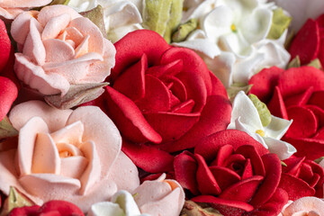 Beautiful arrangement of marshmallow flowers in a white round box, featuring vibrant red, soft pink, and delicate white blooms, showcasing unique floristry concept with copy space
