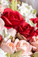 Beautiful arrangement of marshmallow flowers in a white round box, featuring vibrant red, soft pink, and delicate white blooms, showcasing unique floristry concept with copy space