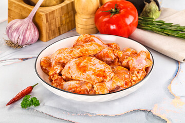Raw marinated uncooked chicken wings