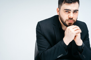 Young handsome man with beard and hand on chin thinking about question, pensive expression. thoughtful face. Doubt concept.
