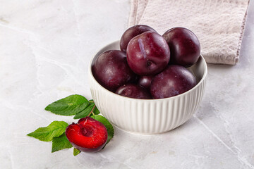 Raw ripe purple plum heap