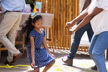 African American family dancing joyfully at outdoor party, celebrating together