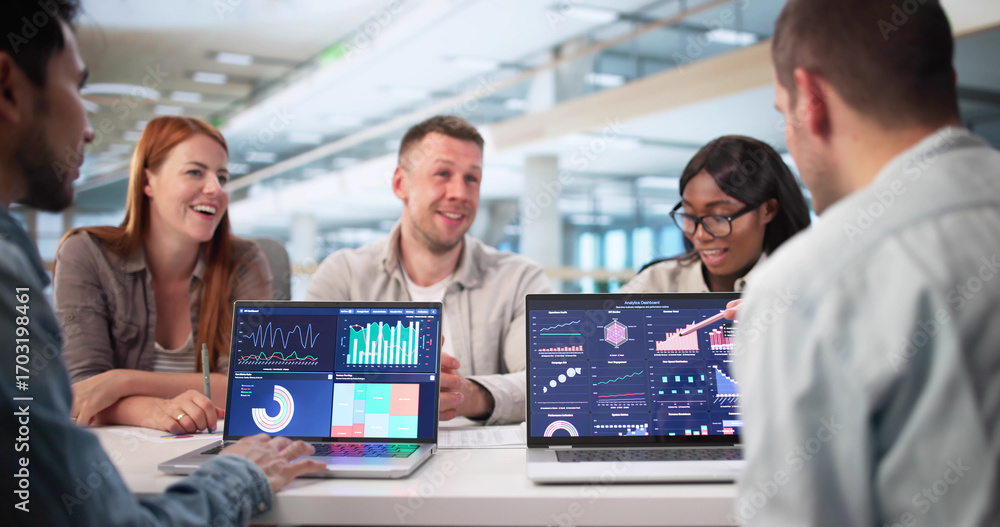 Poster analyzing data with team on business dashboard