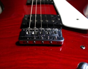 Close-up of a red electric guitar bridge
