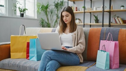 Online Shopping at Home: A woman finds the comfort of home and embraces the thrill of online shopping with colorful shopping bags beside her.